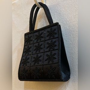 Black evening bag with beaded daisies detailing.